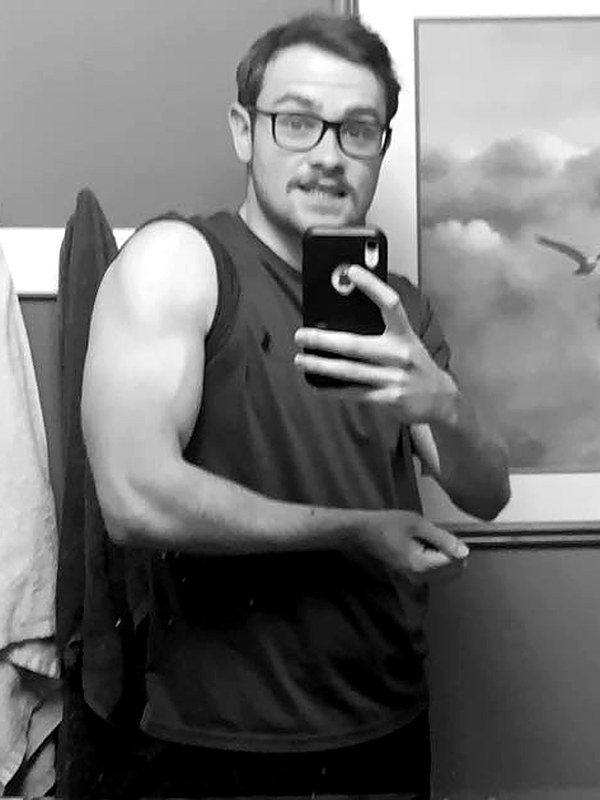 Miller flexing in a sleeveless shirt