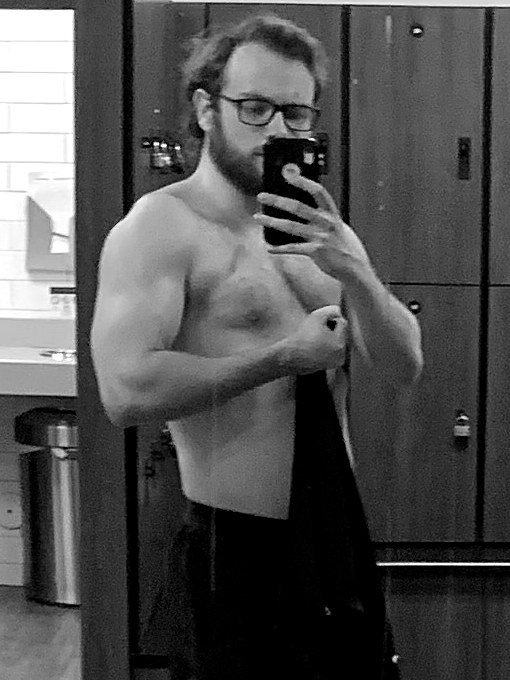 Miller flexing in a gym locker room