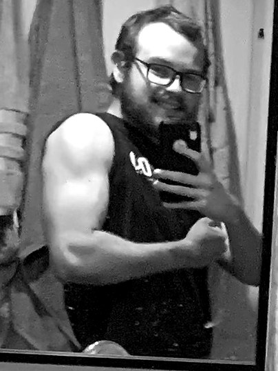 Miller flexing in a sleeveless shirt